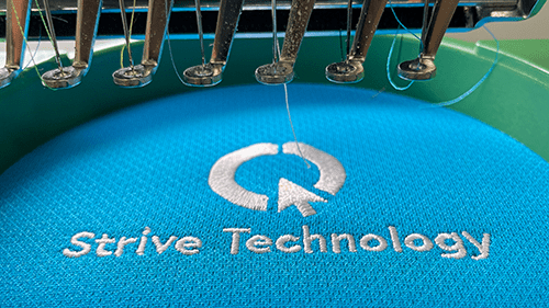 Light blue polo being embroidered.